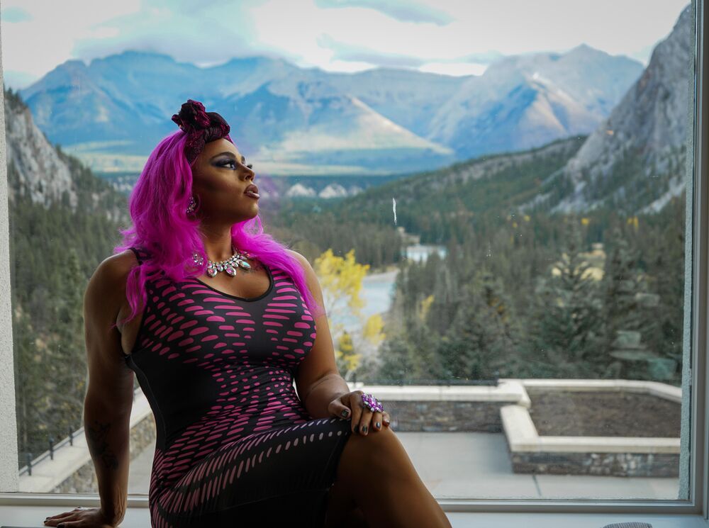 A drag performer sits in a window in the Vermilion Room at the Banff Springs Hotel in Banff National Park.